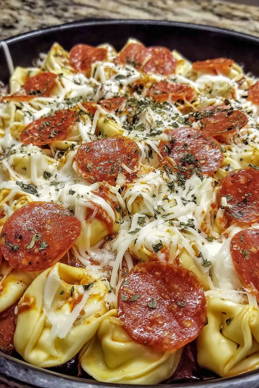 Cheese tortellini with creamy cheese sauce in a casserole dish