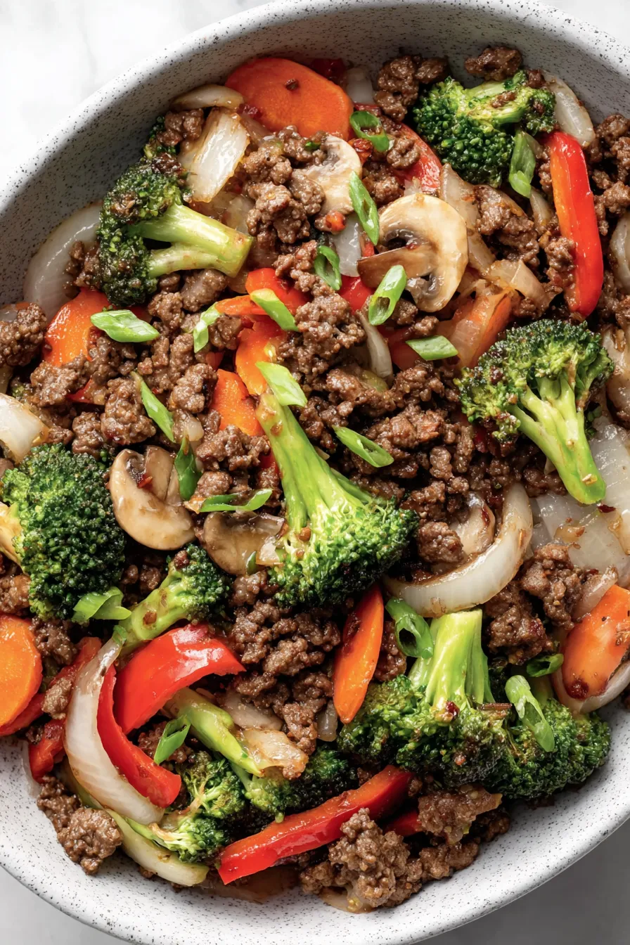Ground beef stir fry in skillet with vegetables