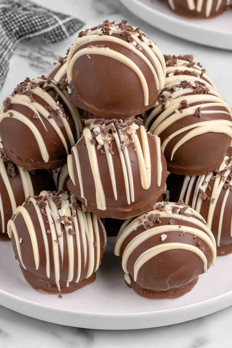 Kahlua balls on parchment with chocolate drizzle
