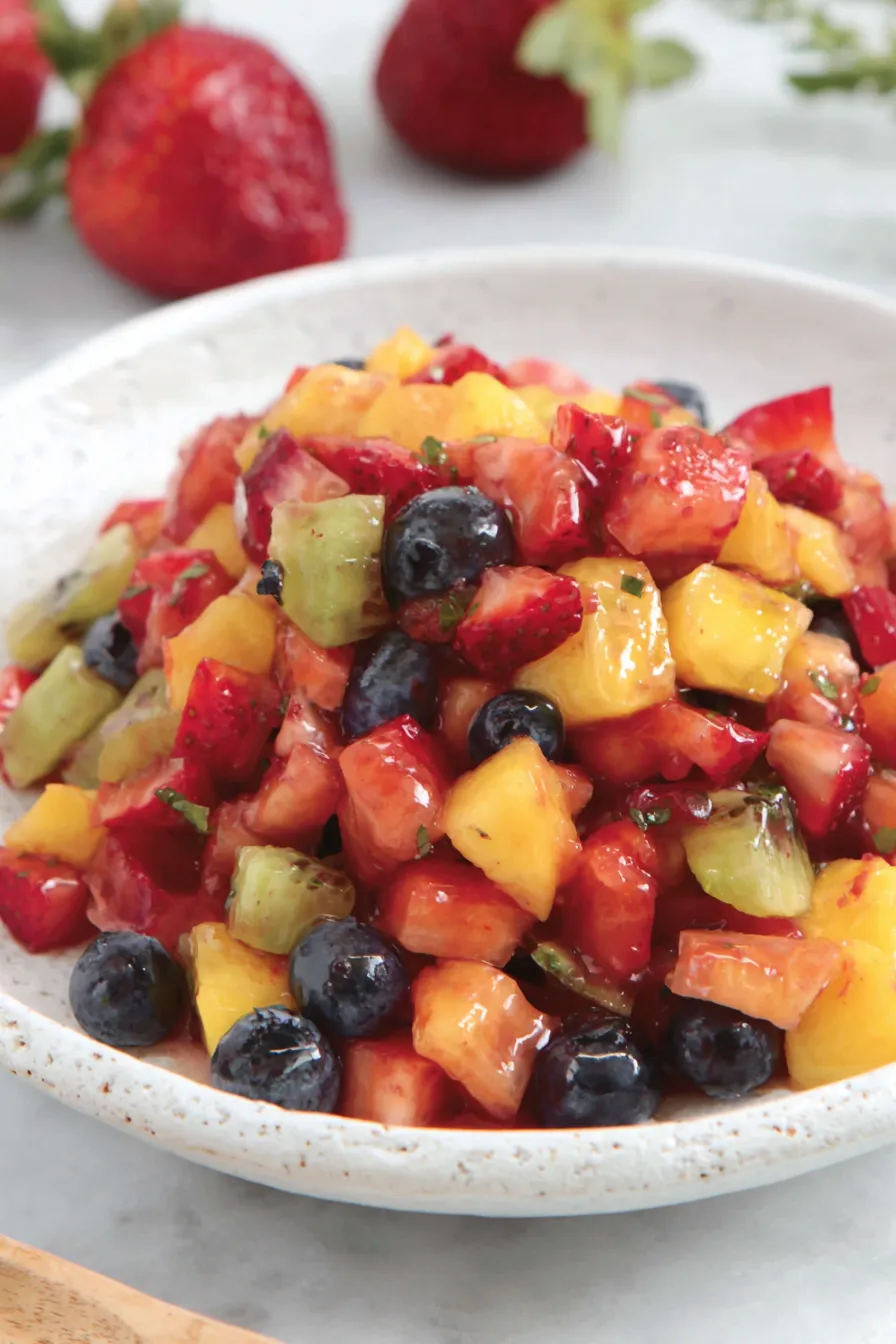 Fresh fruit salsa in a bowl next to cinnamon chips