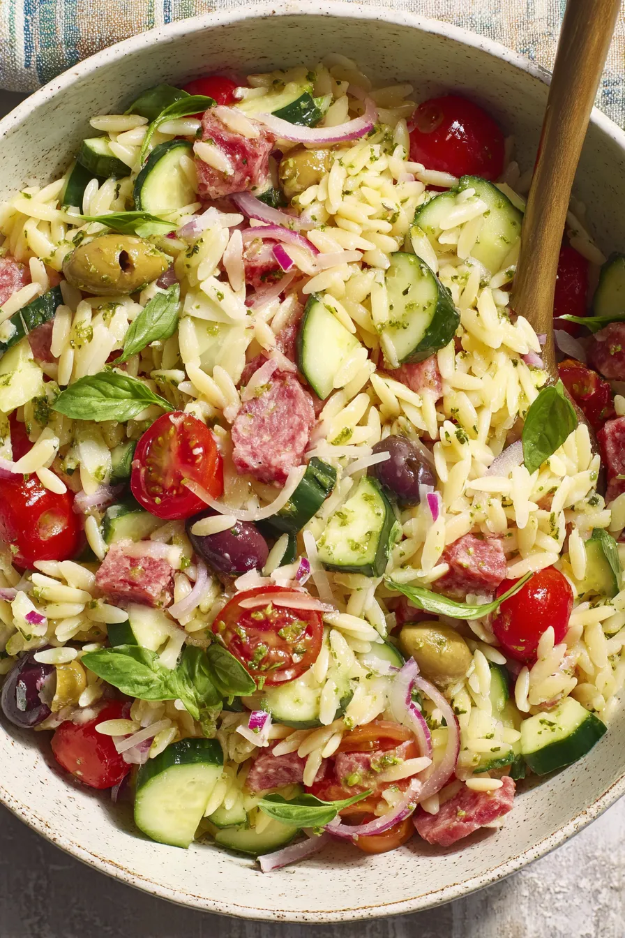 Bowl of Italian orzo salad with olives and tomatoes