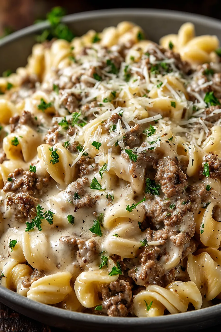 Serving of creamy pasta topped with parsley on a plate
