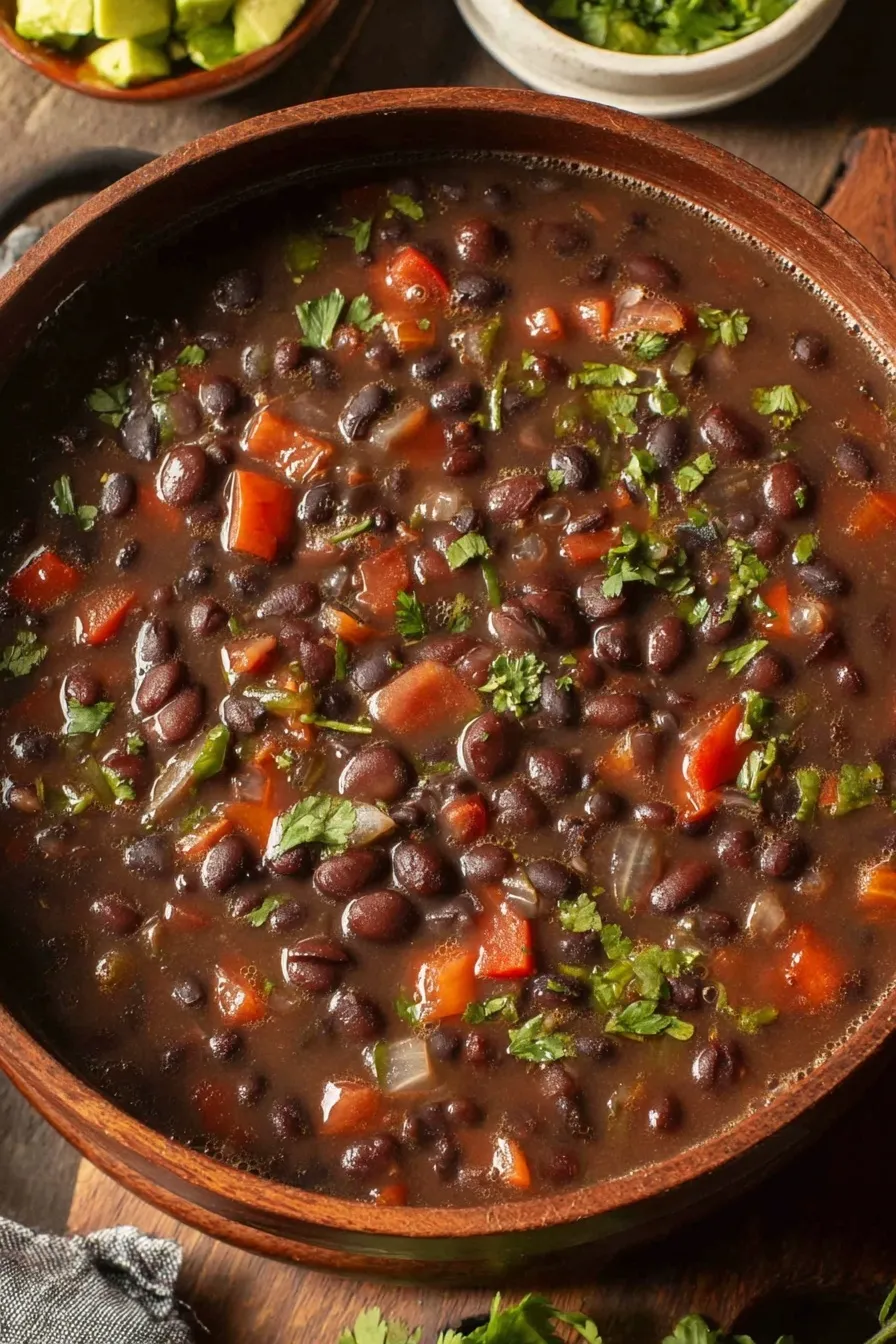 Bowl of spicy black bean soup with toppings