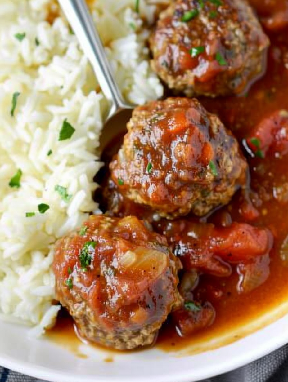 Porcupine meatballs simmering in gravy in a skillet