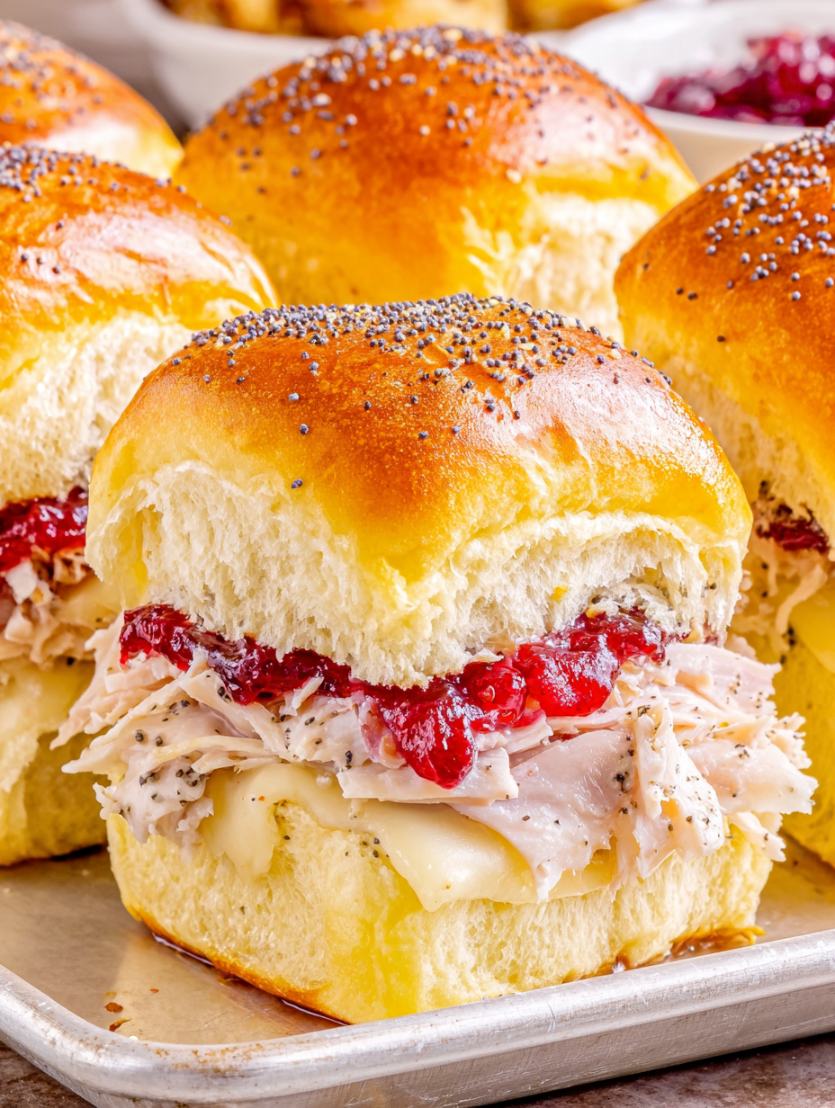 Assembled turkey and cheese sliders ready to bake