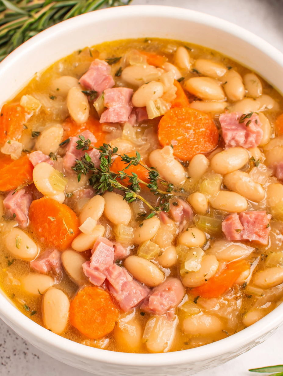 White bean soup with ham simmering in a pot