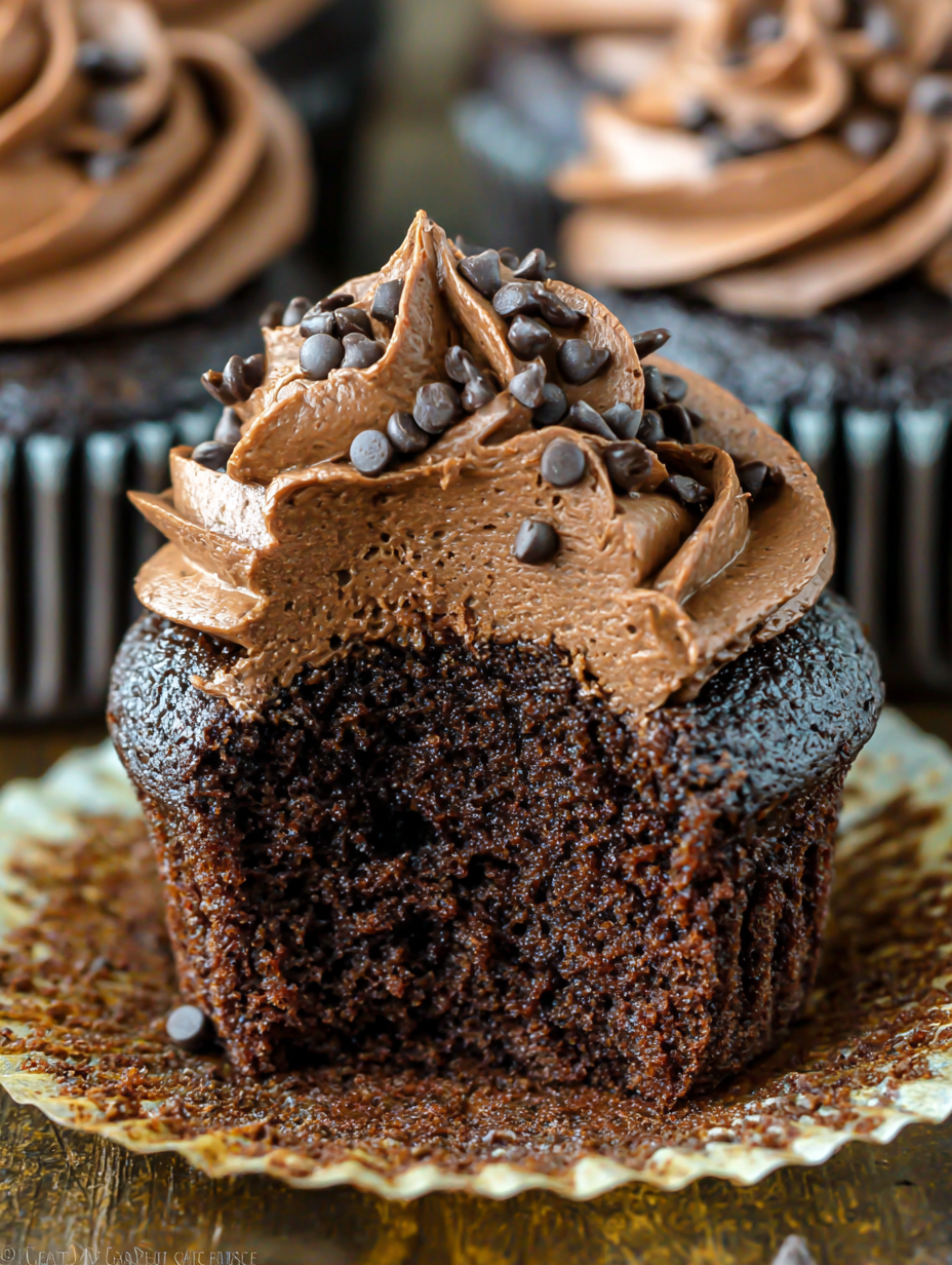 Piped chocolate buttercream on cupcakes