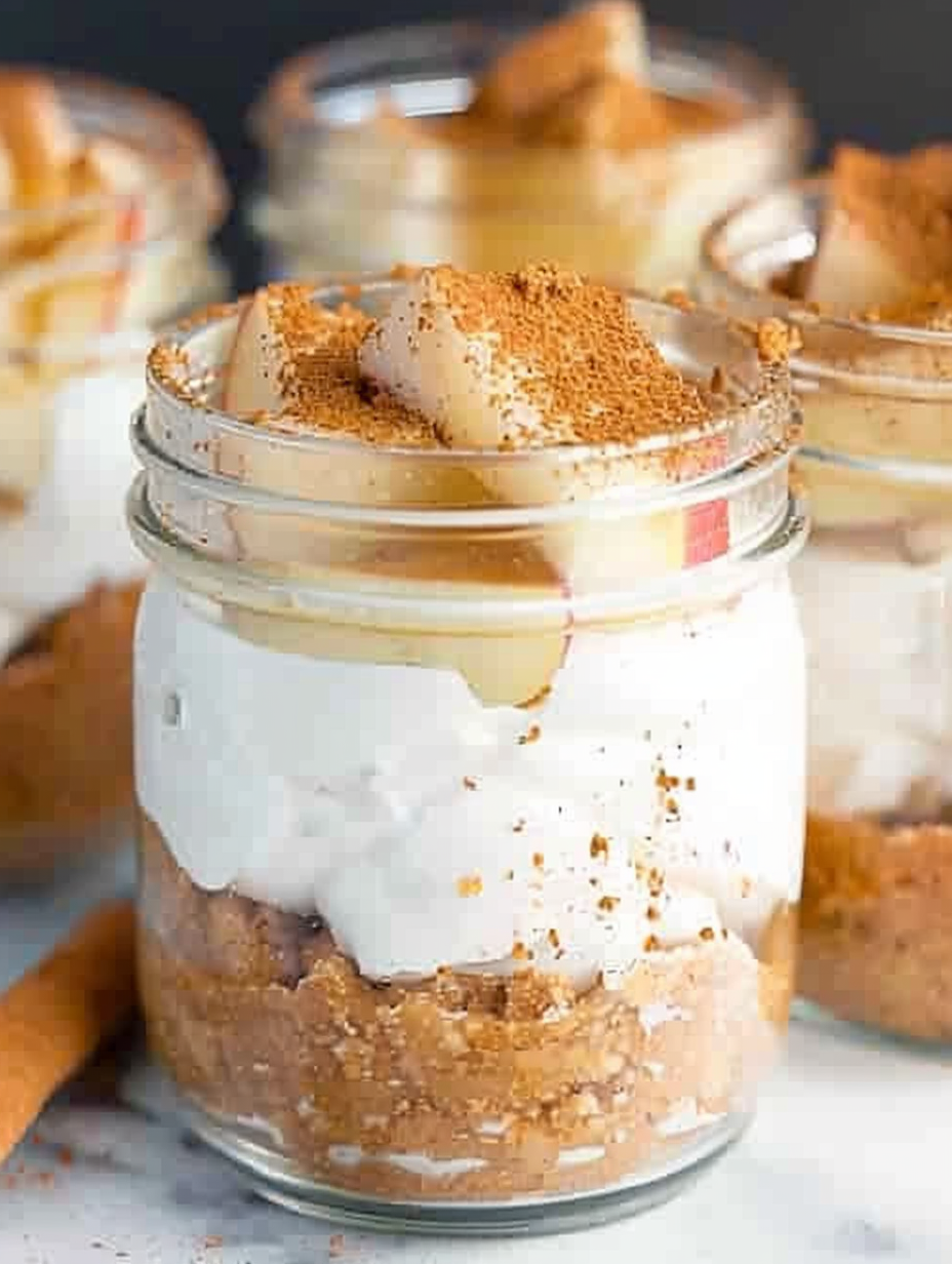Layered apple pie cheesecake in mason jars