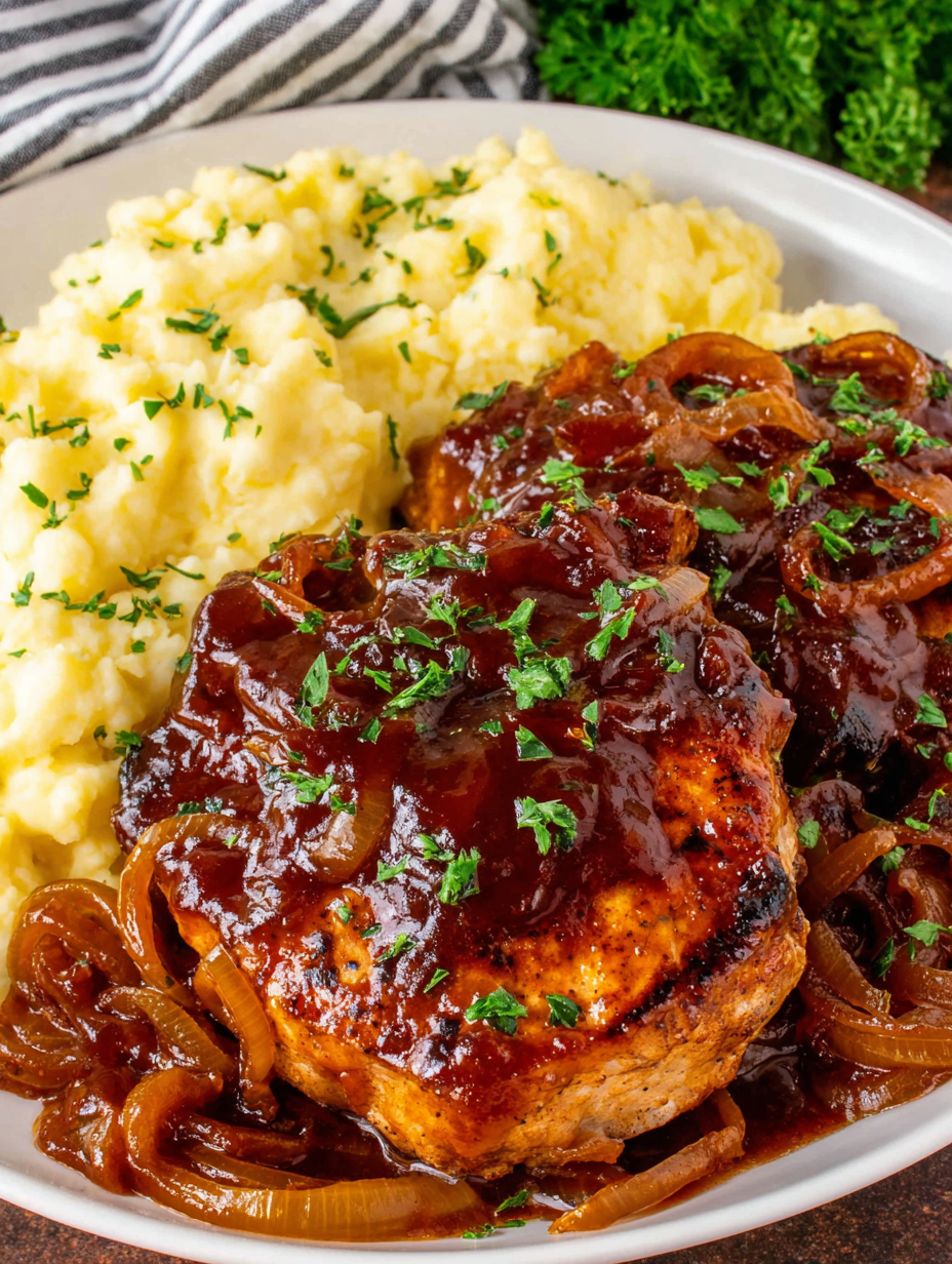 Plated apple butter pork chop with mashed potatoes