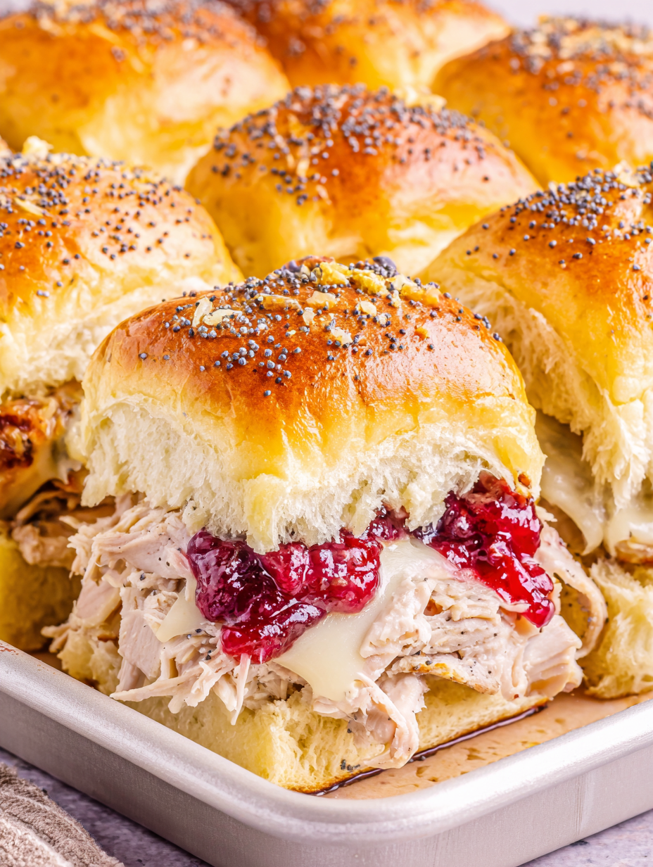 Close-up of baked turkey and cheese sliders on Hawaiian rolls