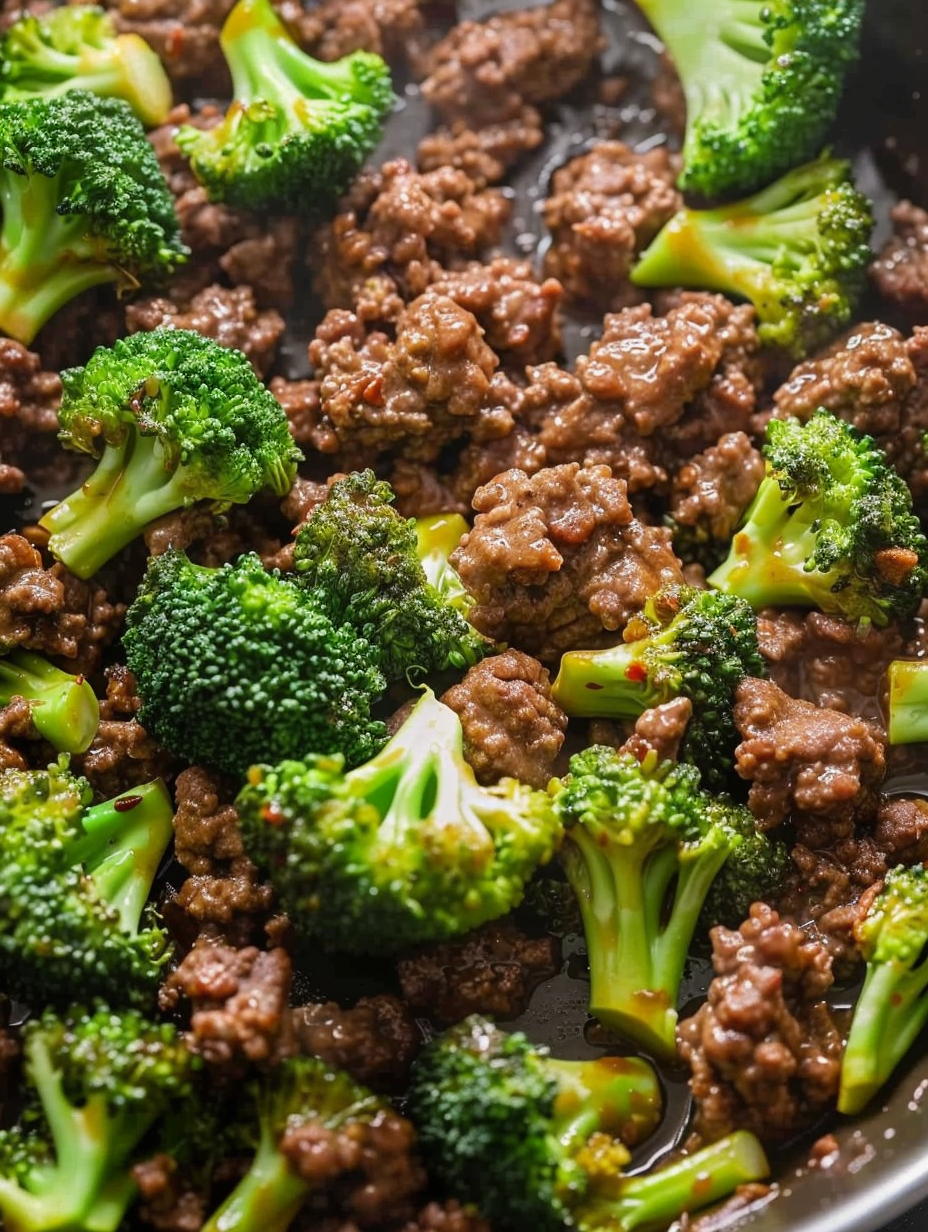 Ground beef and broccoli in a cast iron skillet