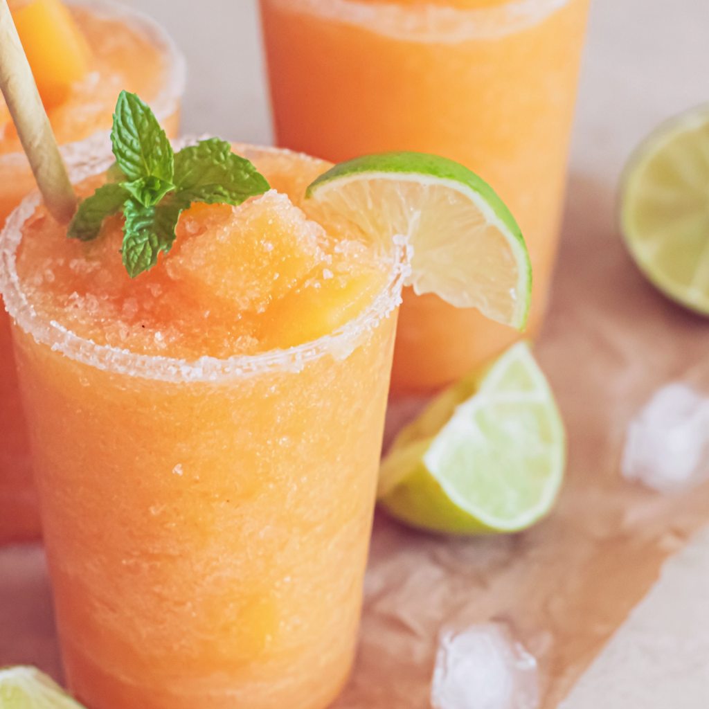 Salty melon slush poured into chilled coupe glasses with mint