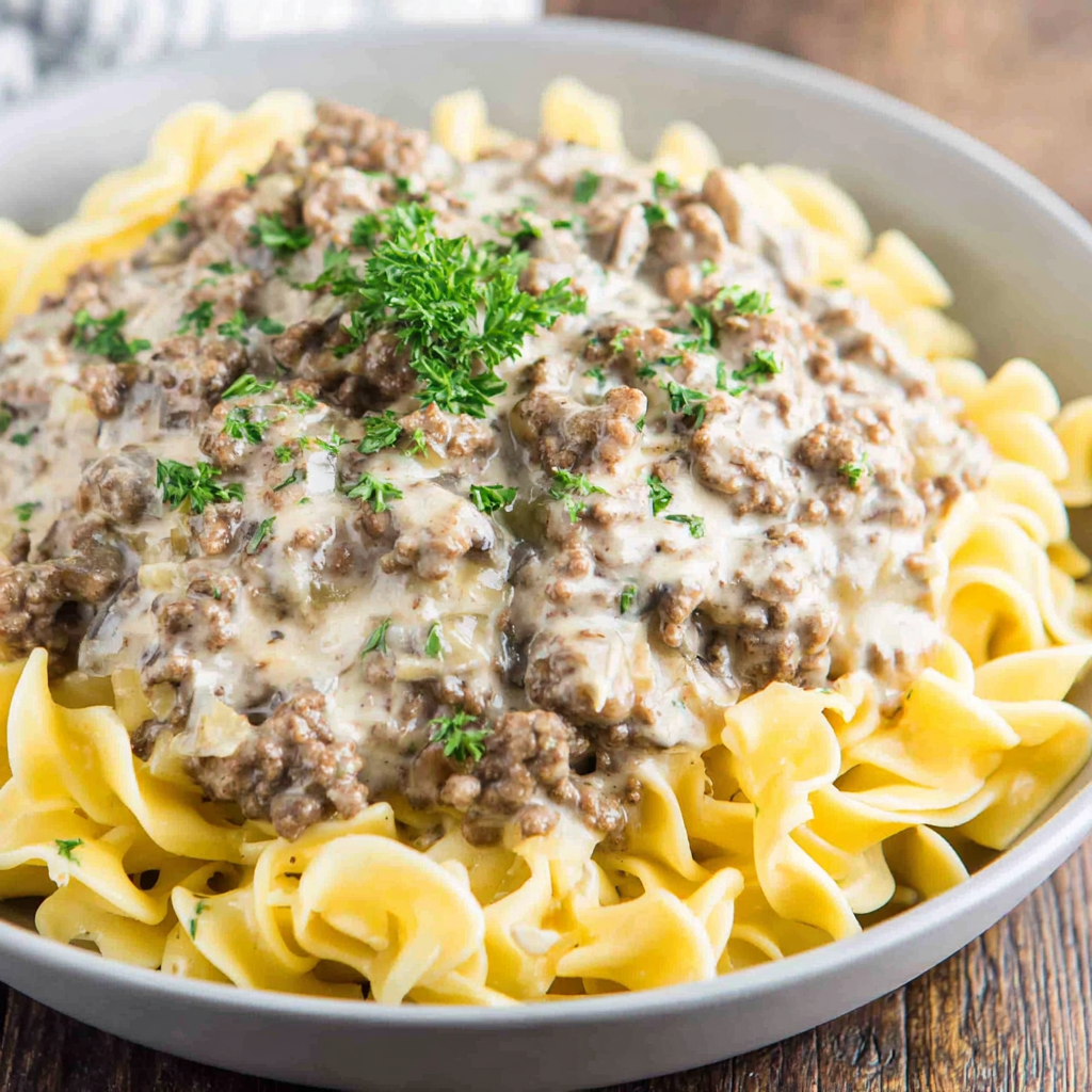 Close-up of egg noodles topped with creamy beef stroganoff