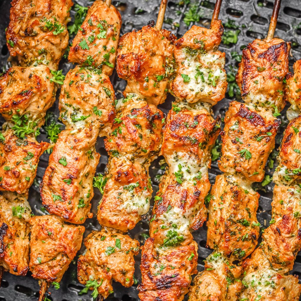 Plated garlic Parmesan chicken skewers with lemon and herbs