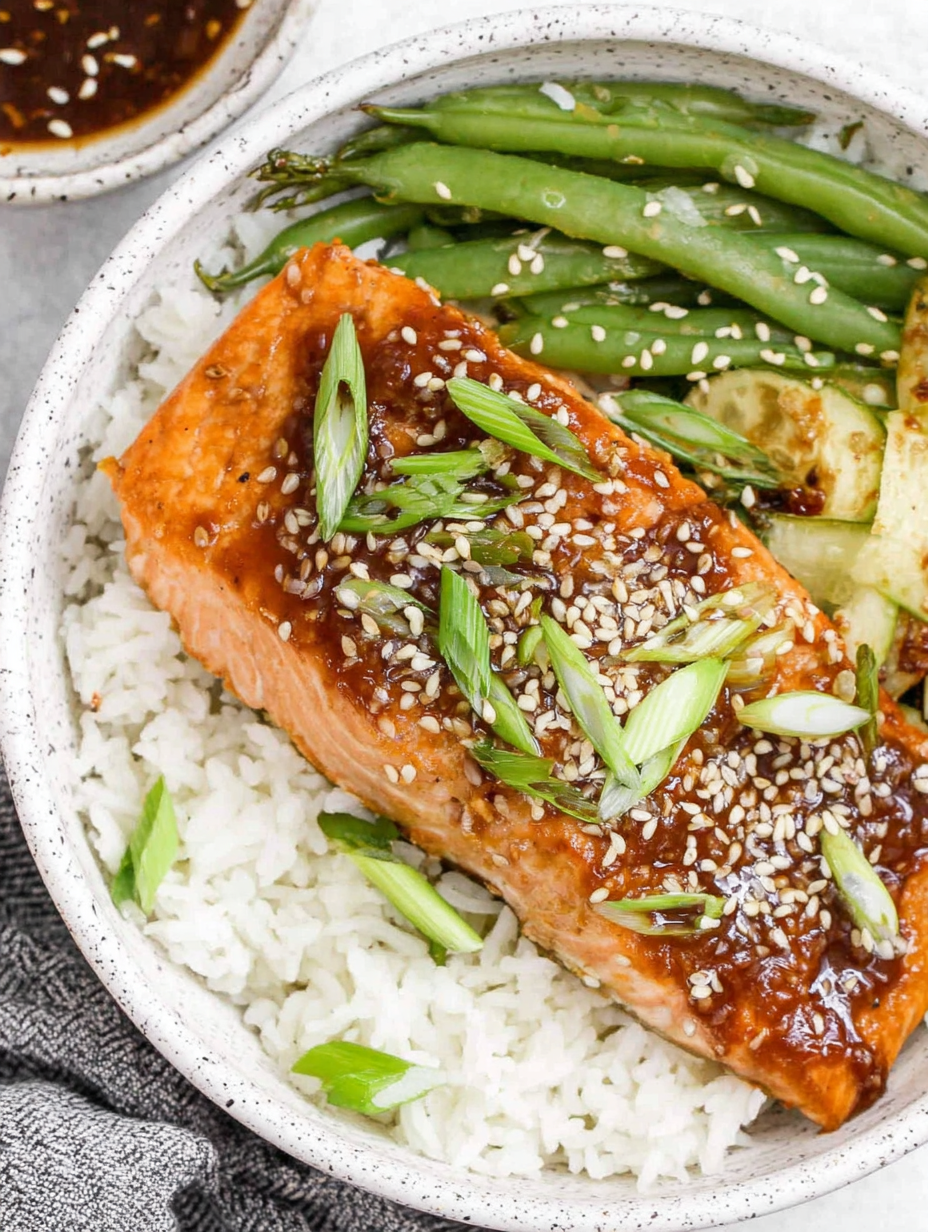 Garlic ginger glazed salmon on parchment with glaze spooned over