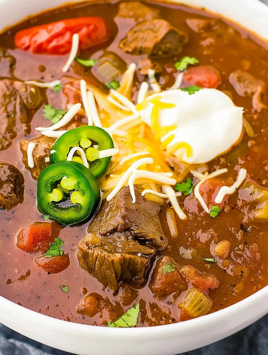 Bowl of Texas chili topped with cilantro and onion