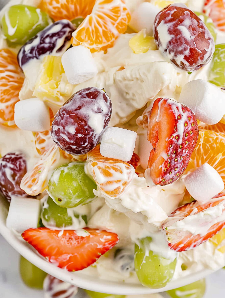 Pudding fruit salad in a white bowl with colorful fruit