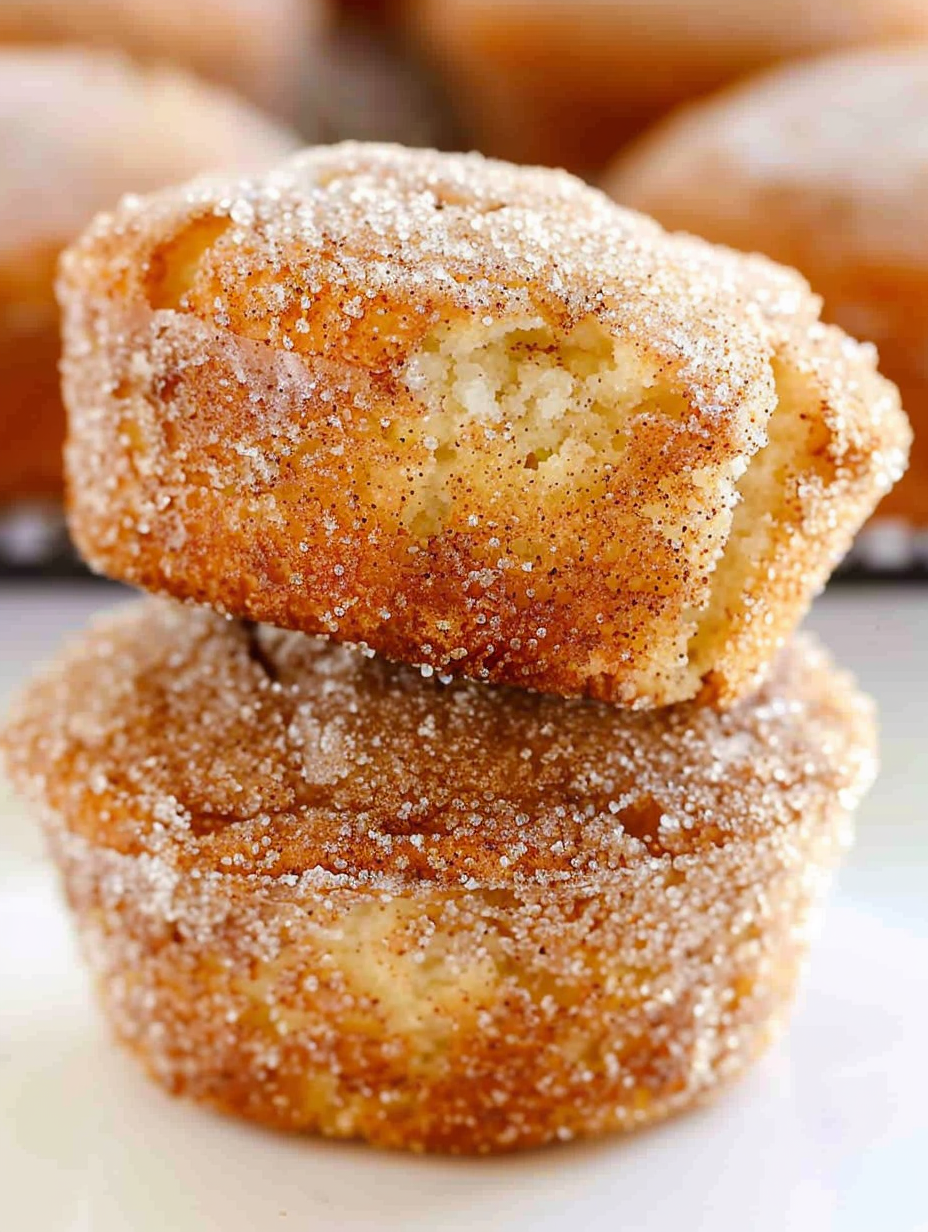 Freshly baked cinnamon sugar donut muffins cooling on a rack