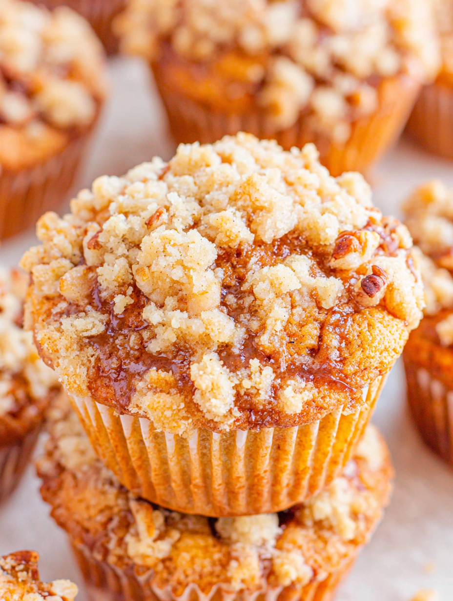 Freshly baked apple muffins with crumb topping on a cooling rack