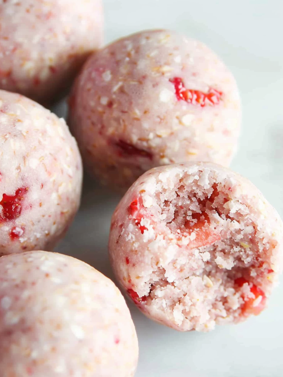 Strawberry protein balls arranged on a plate