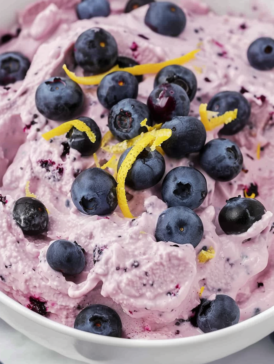 Blueberry fluff in serving bowl with fresh blueberries