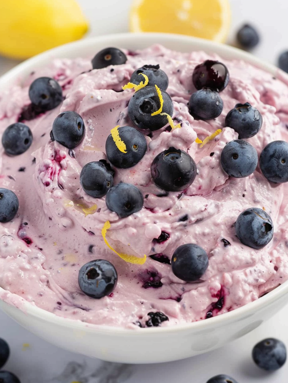 Serving of blueberry fluff with lemon zest garnish