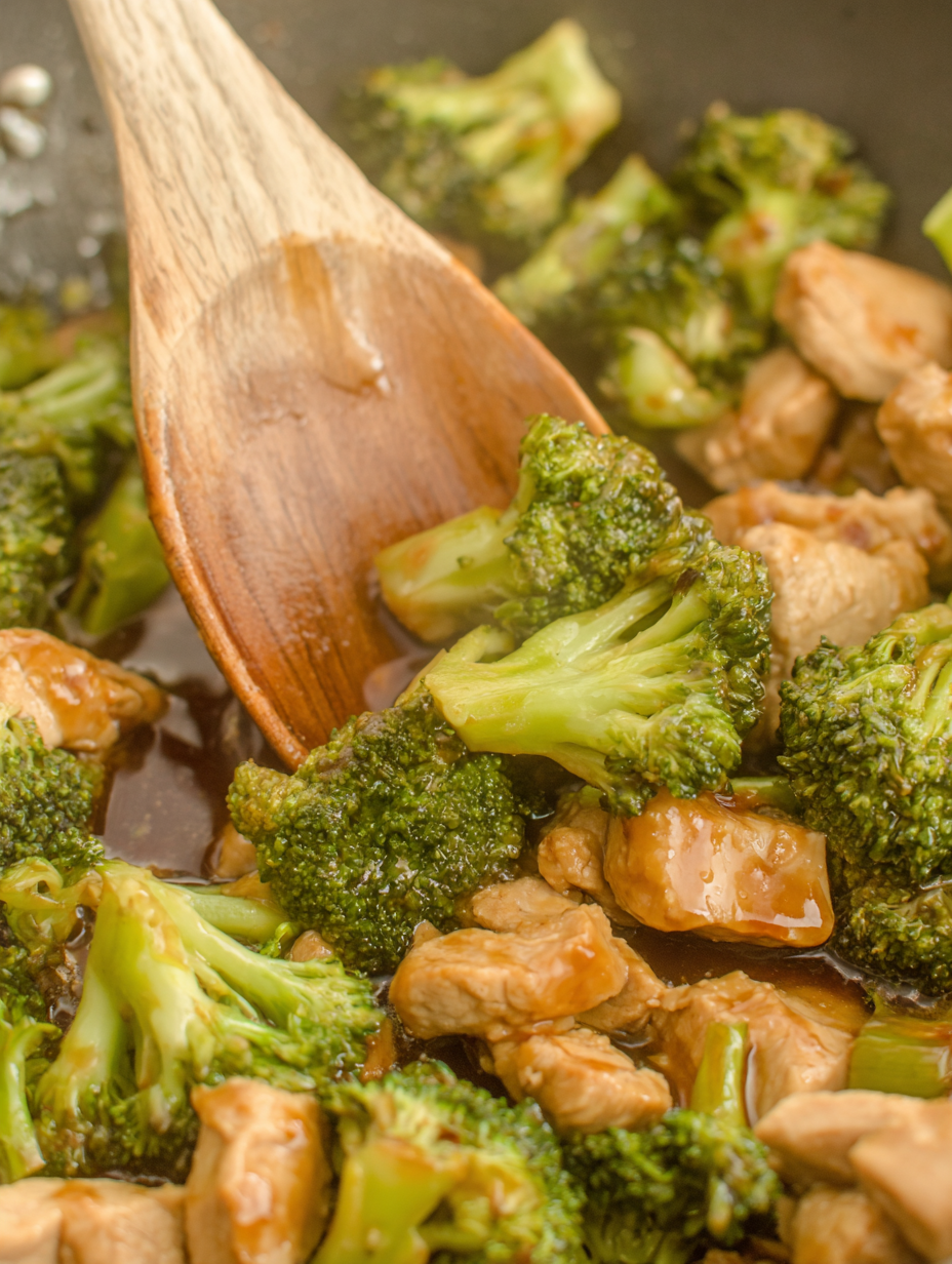 Teriyaki pork sizzling in skillet with broccoli