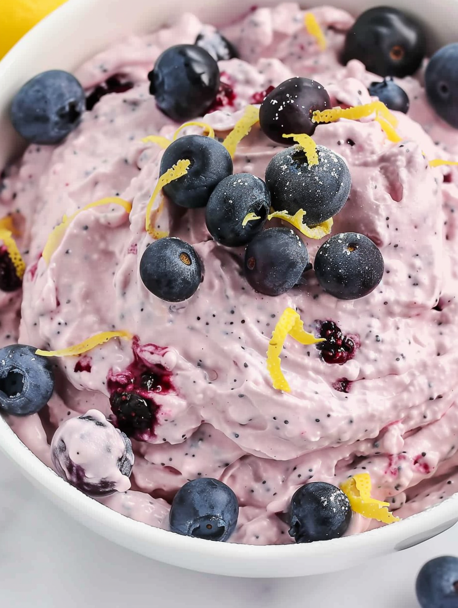 Close up of glossy blueberry pie filling and fresh berries