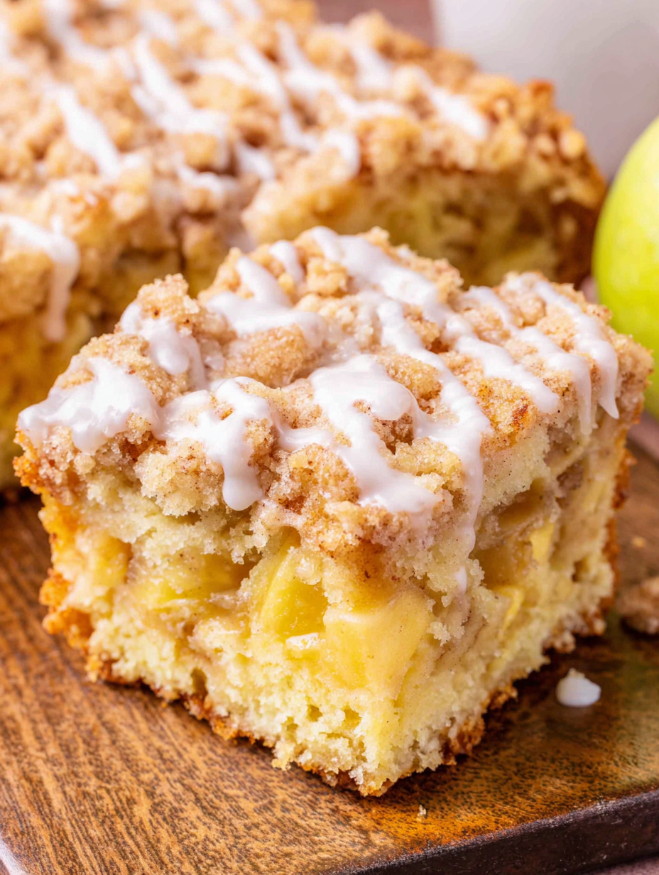Sliced apple coffee cake on a serving plate
