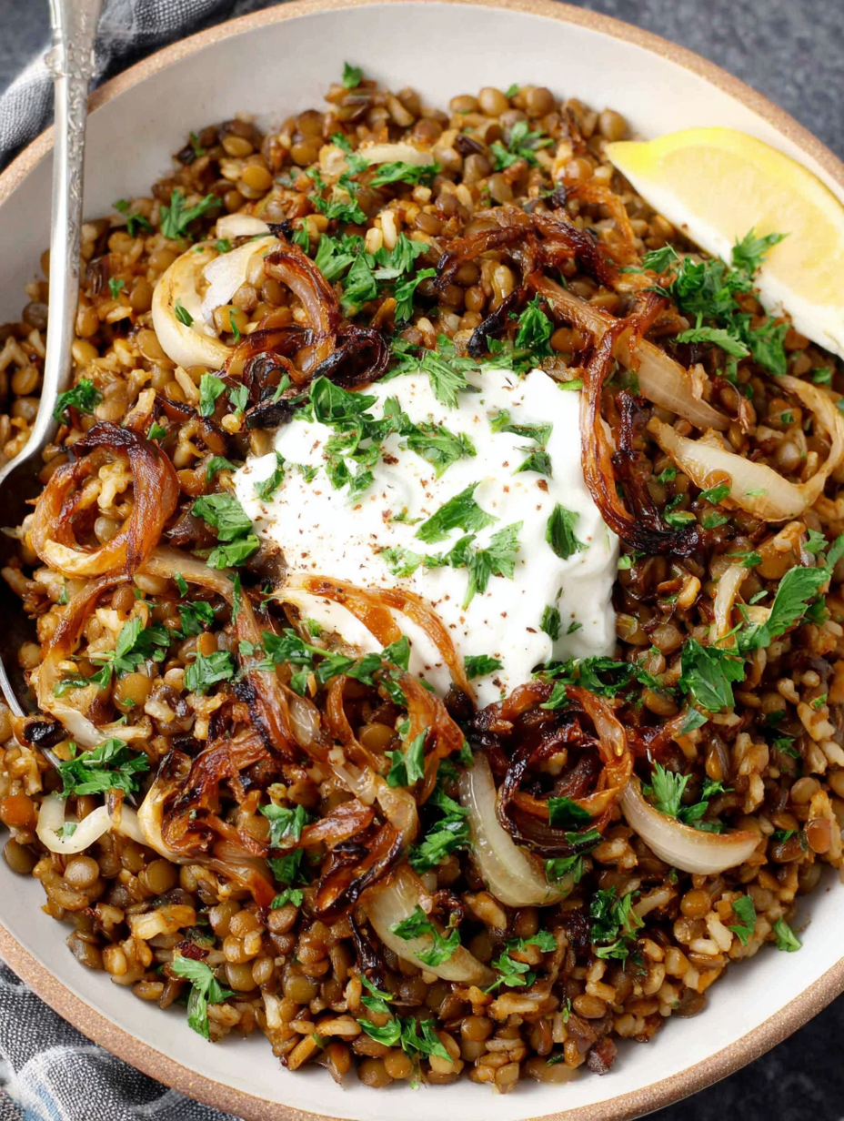 Mujadara in a bowl topped with caramelized onions