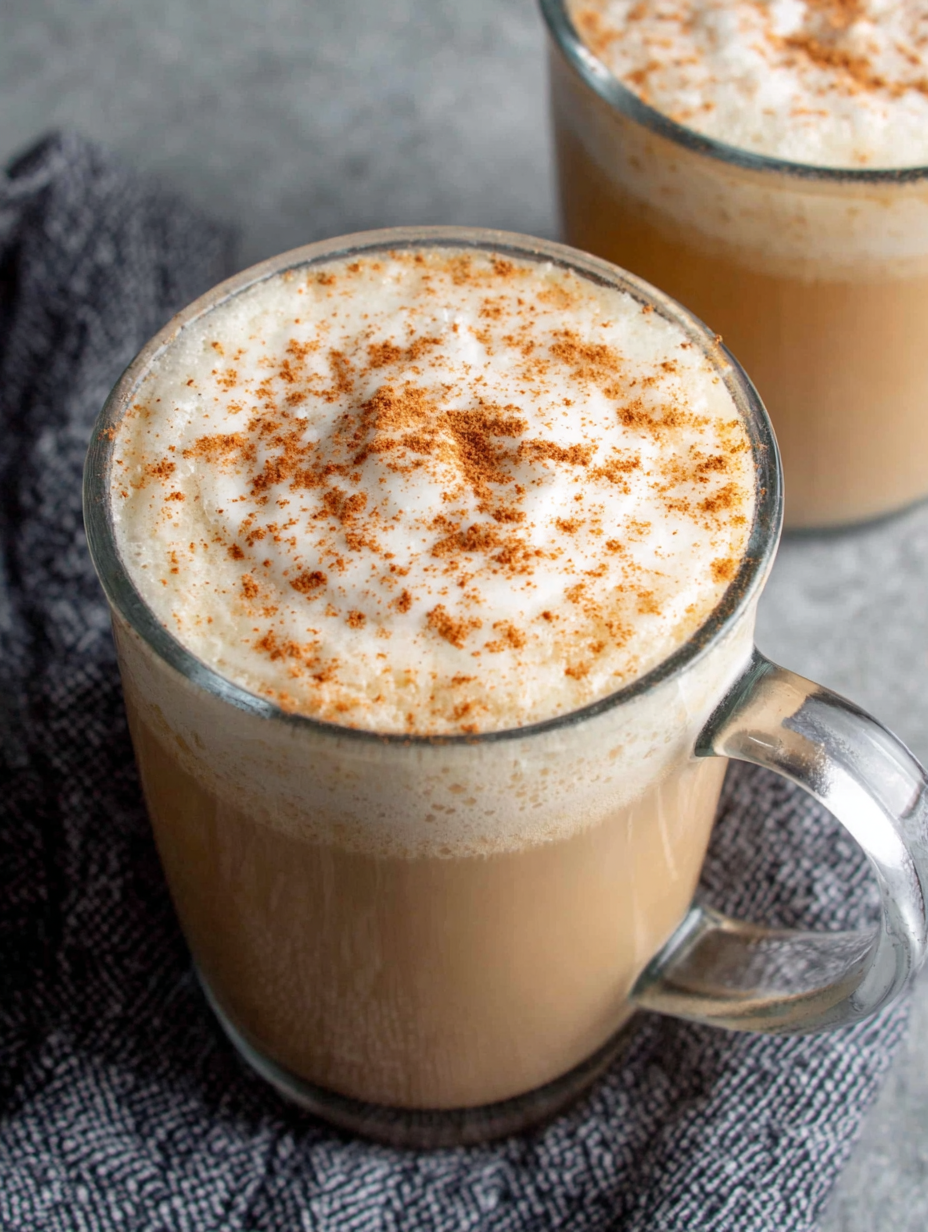 A warm cup of chai tea latte topped with cinnamon