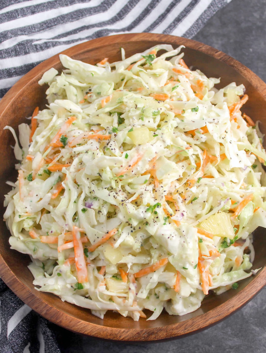 Serving spoon scooping Hawaiian coleslaw from a bowl