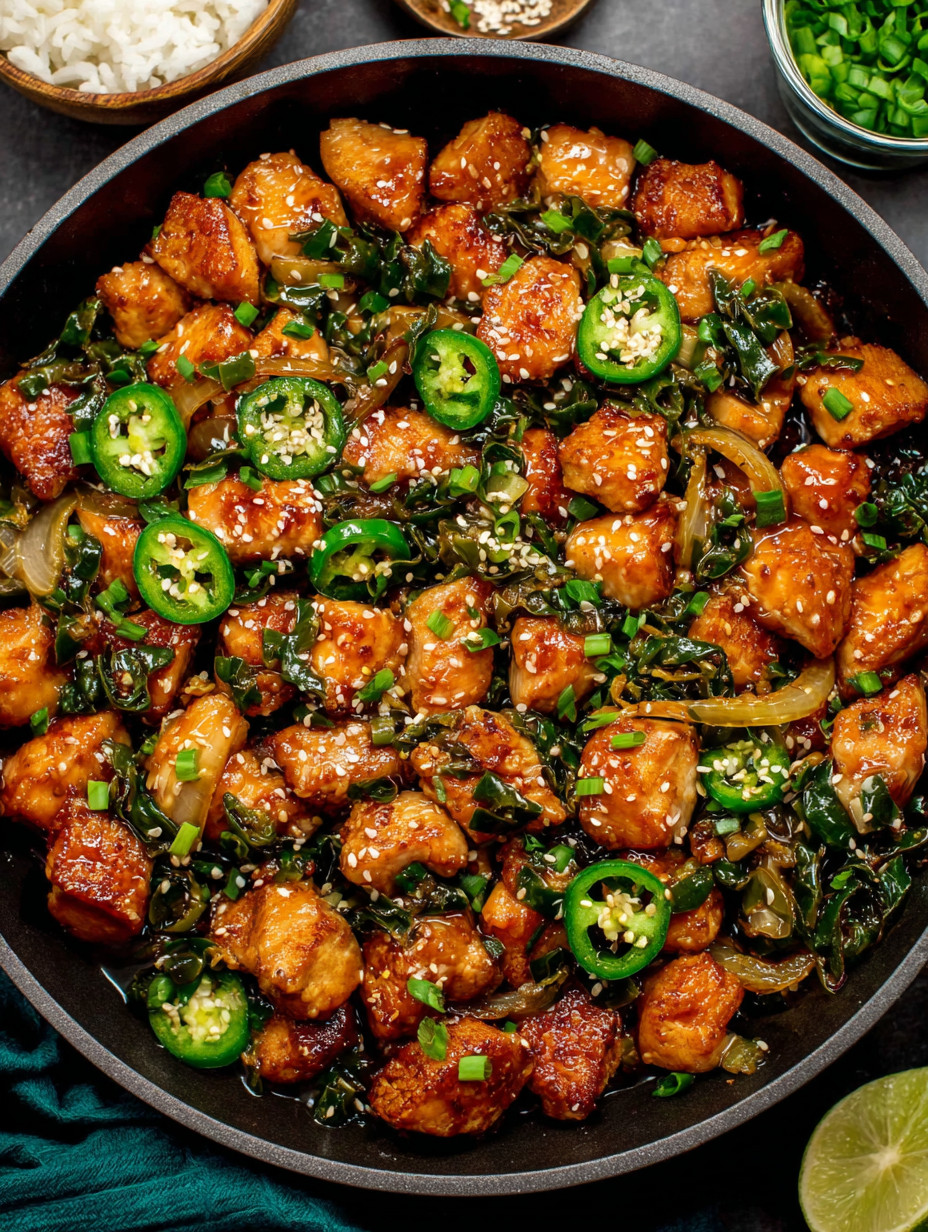 Served jalapeno chicken over white rice garnished with sesame seeds