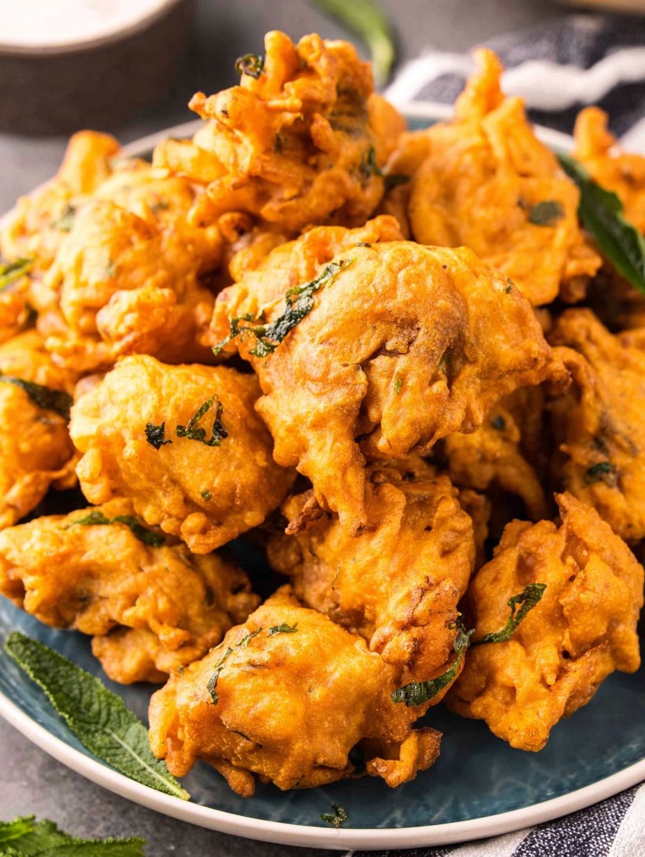Plated chicken pakoras with lemon wedges