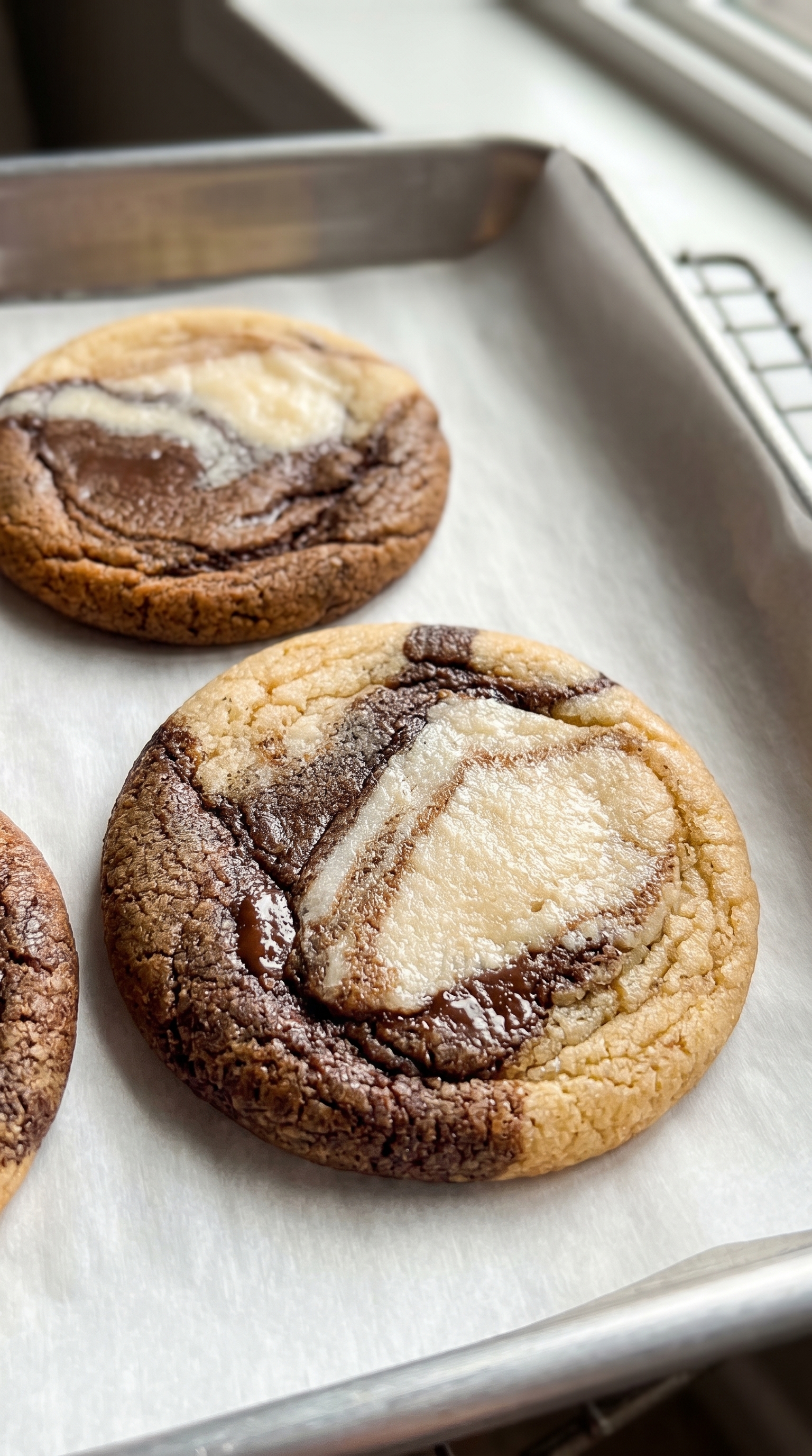 Vietnamese coffee marble cookies fresh from the oven on a parchment lined tray