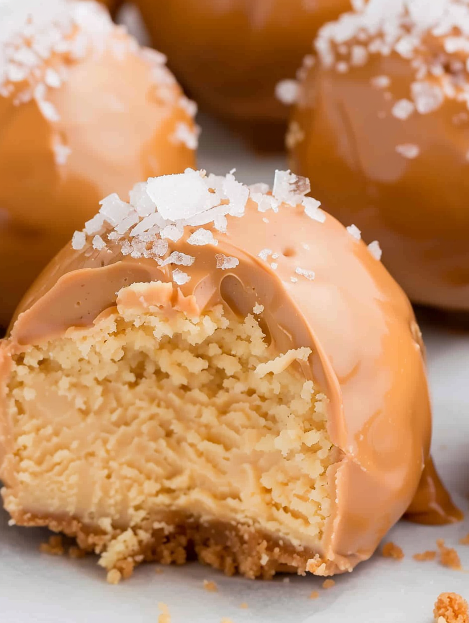Two caramel cheesecake bites on parchment