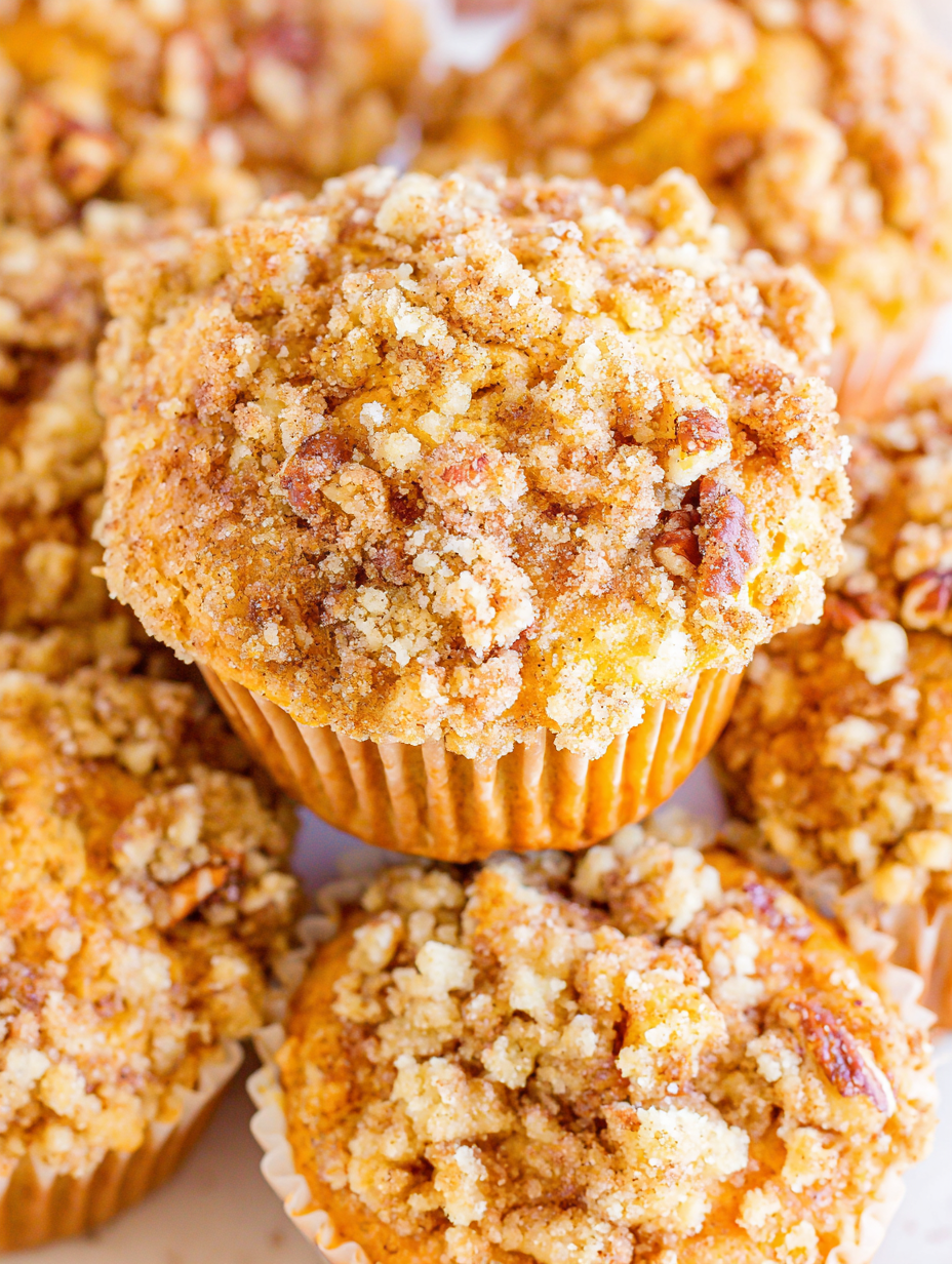 Close-up of crumb topping being sprinkled on muffins