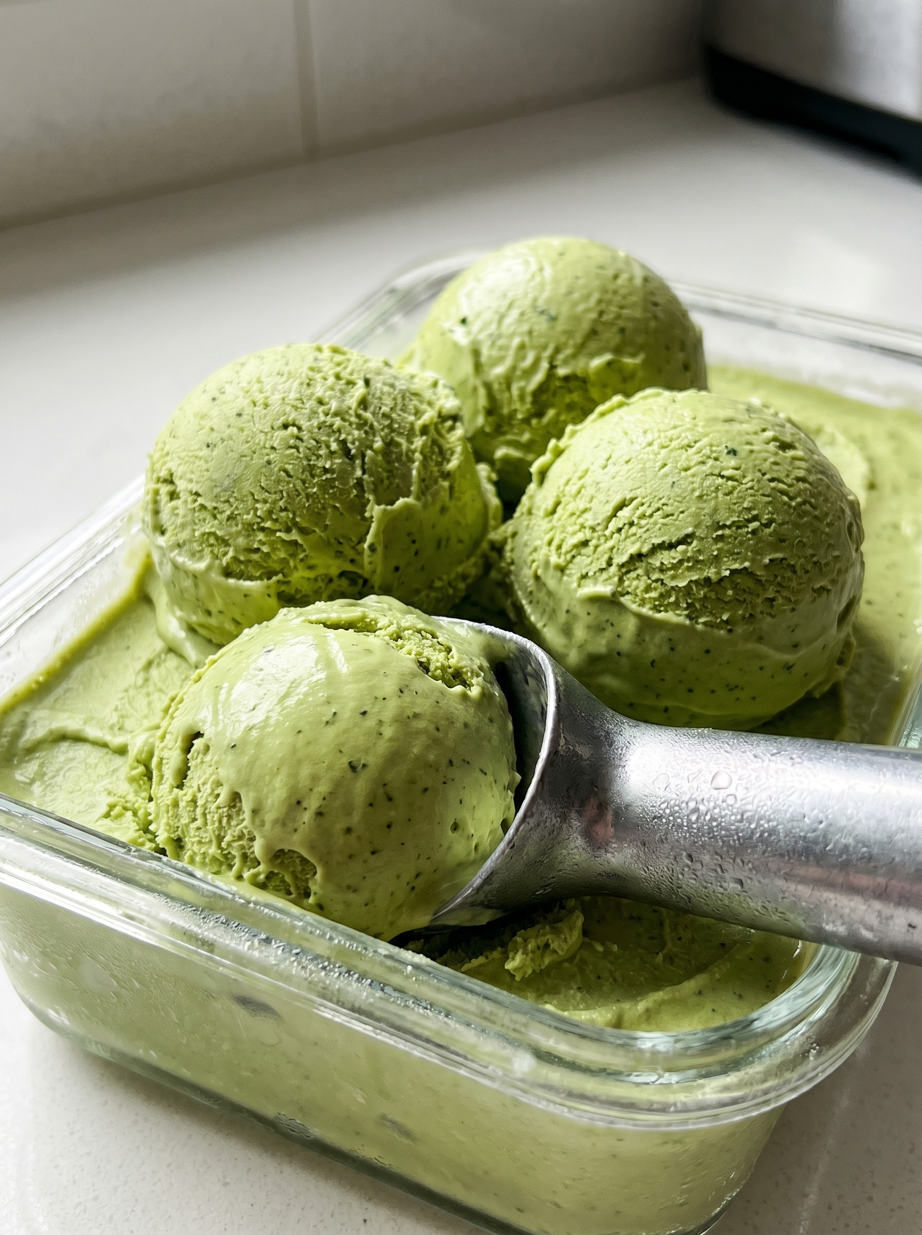 Matcha powder and fresh scoops on a spoon