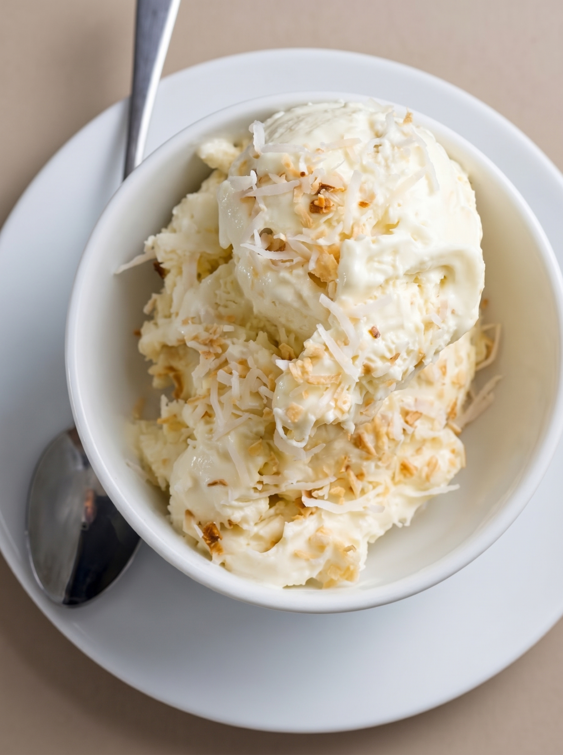 Close-up of toasted shredded coconut being stirred