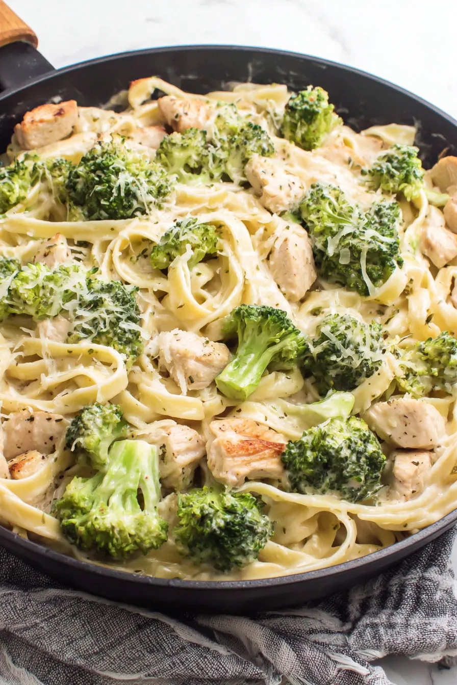 Creamy fettuccine with chicken and broccoli in skillet