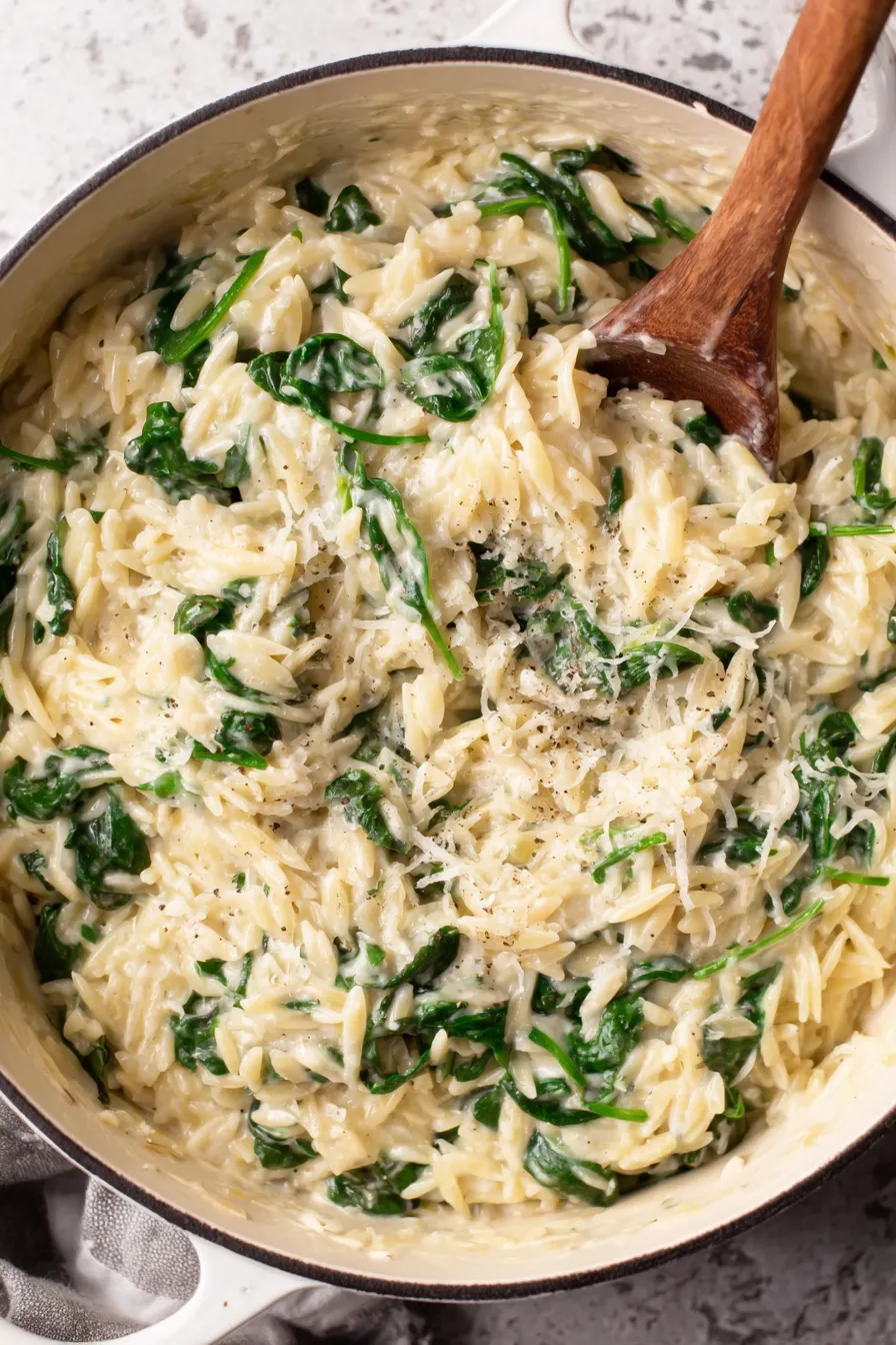 Bowl of orzo with wilted spinach and parmesan