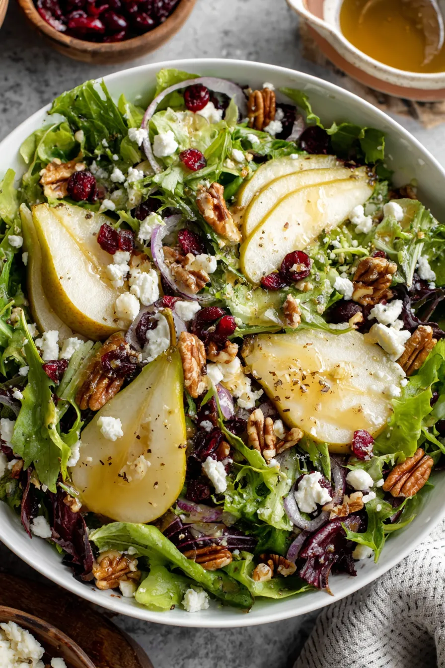 Pear salad with nuts and feta on a wooden table