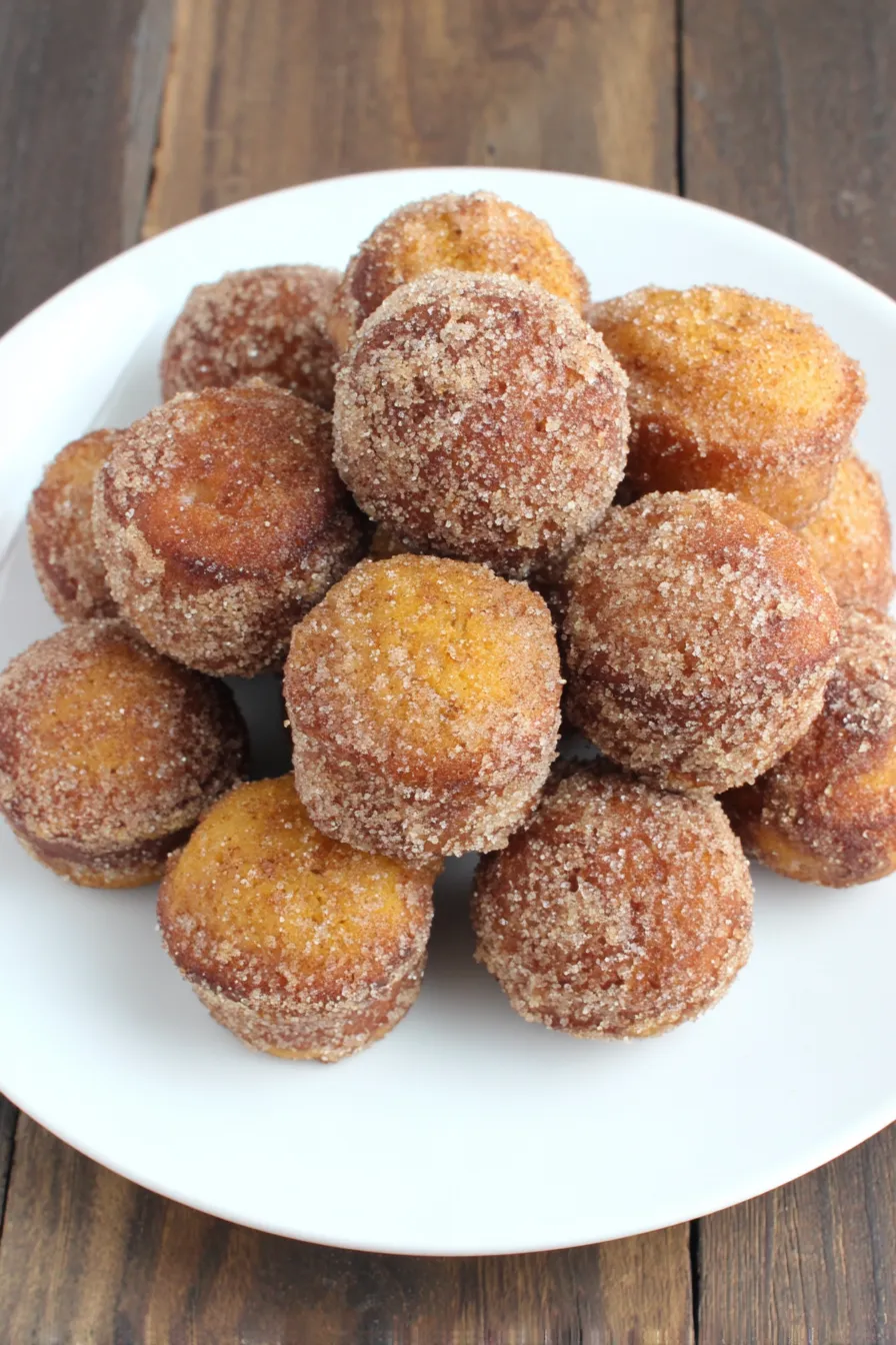 Close-up of a single pumpkin donut hole showing tender crumb