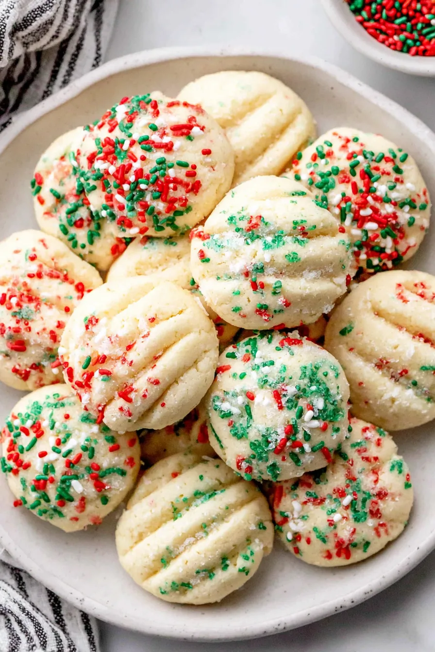 Shortbread cookies on a tray with sprinkles