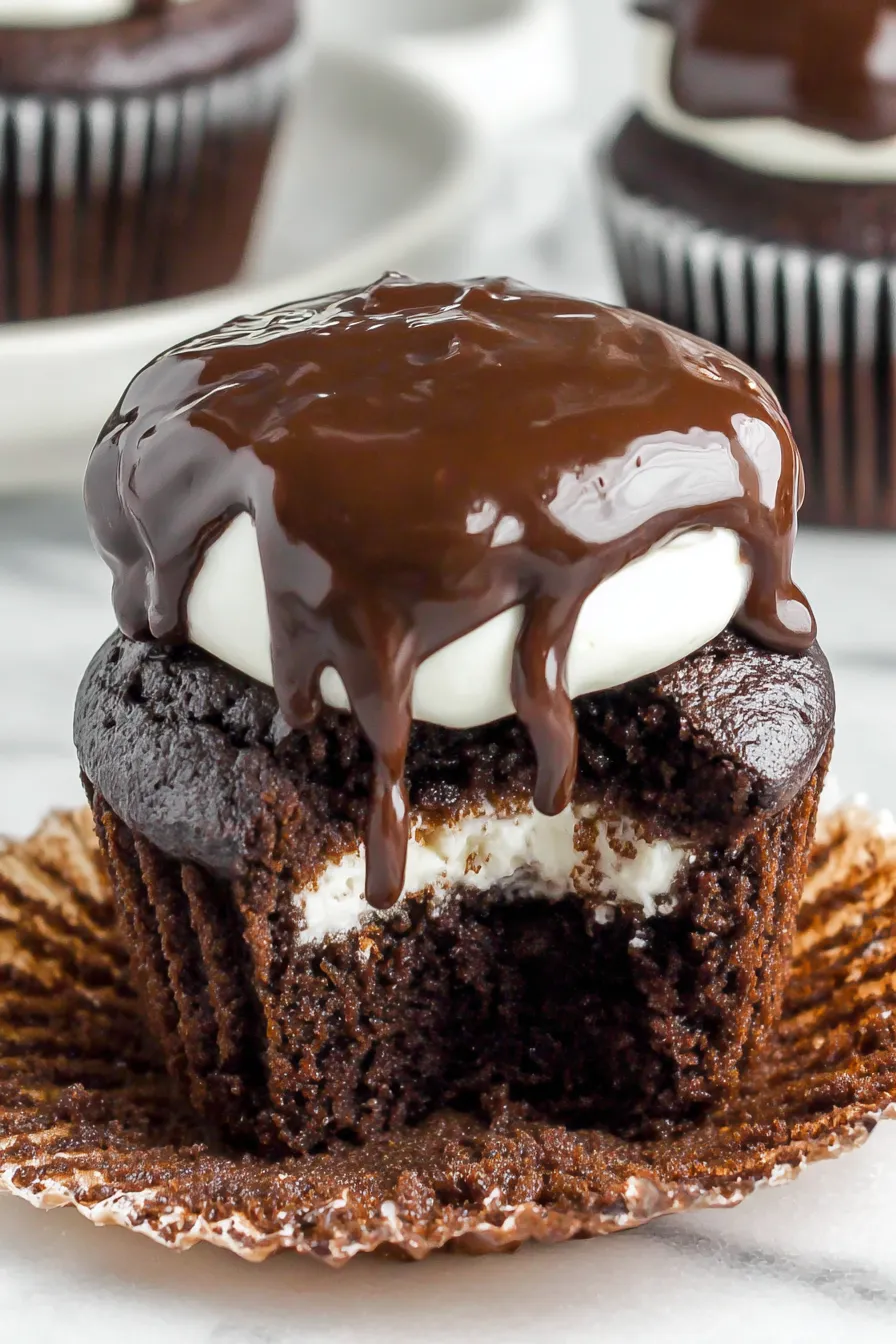 Tray of iced Hostess style cupcakes cooling on a rack