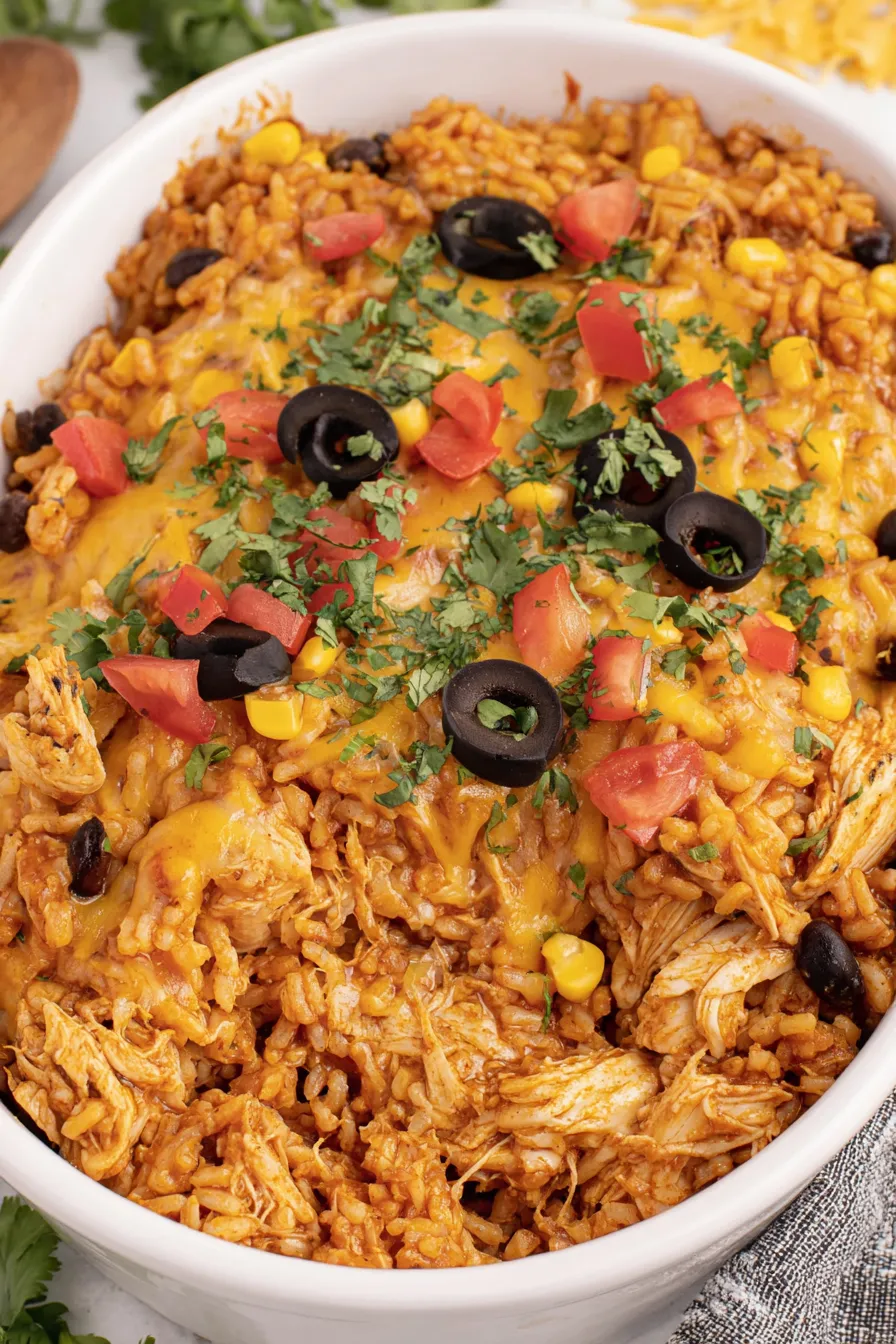 Baked chicken enchilada rice casserole with melted cheese