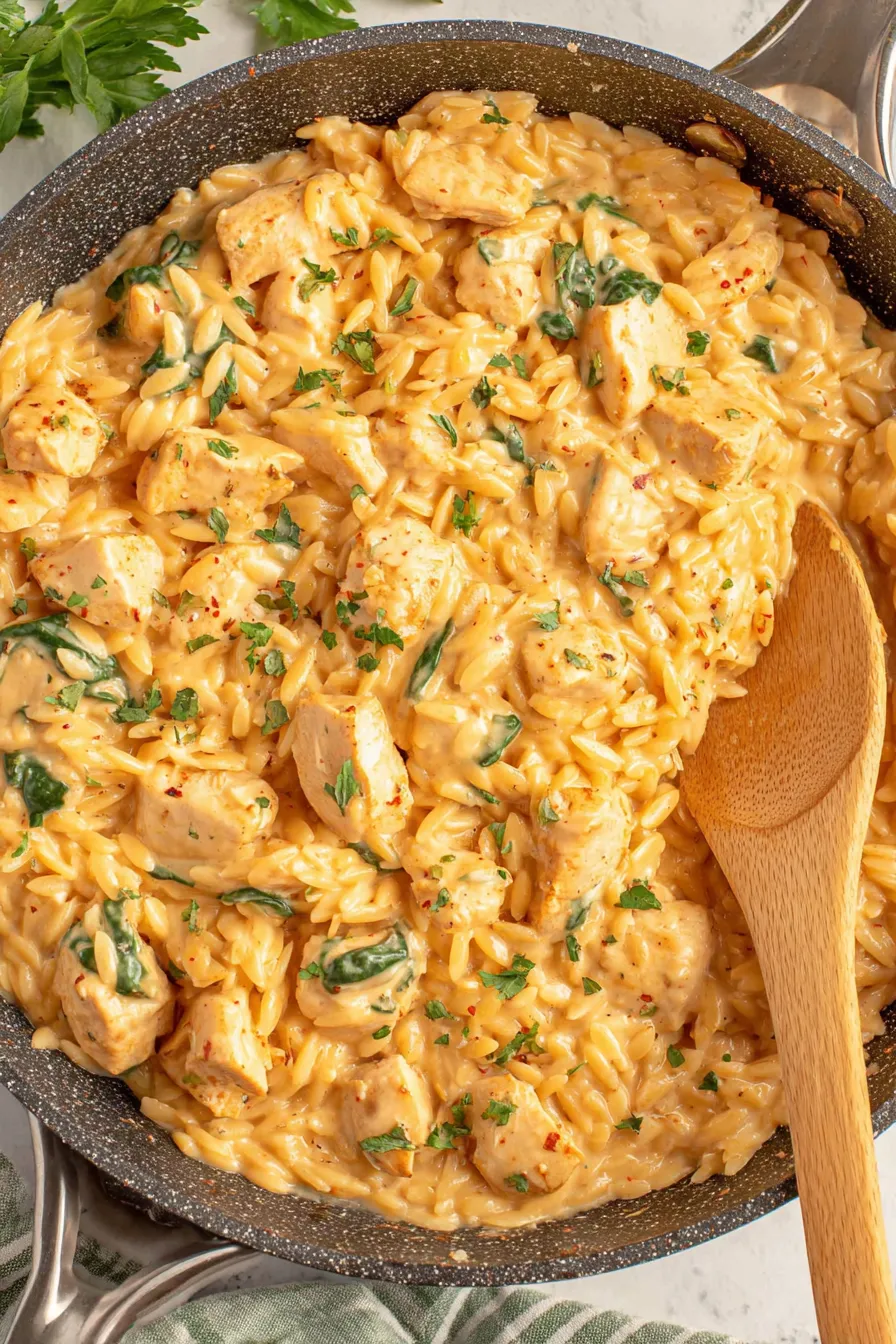 Two bowls of creamy chicken orzo with spinach
