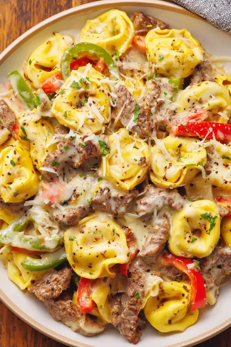 Crock Pot Cheesesteak Tortellini bubbling in slow cooker