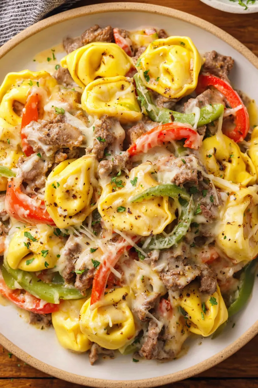 Bowl of cheesesteak tortellini garnished with parsley