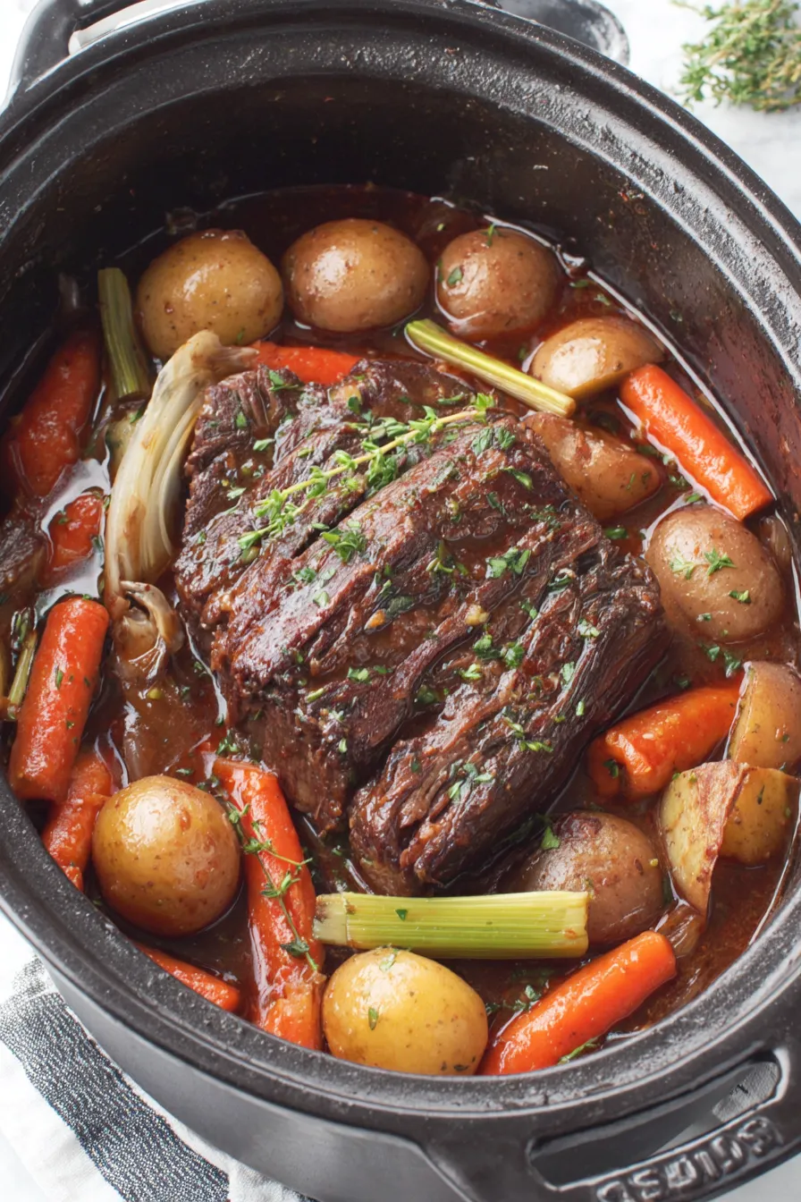 Seared chuck roast in a Dutch oven with vegetables